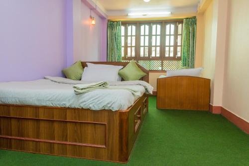 A bed or beds in a room at Swastik Guest House