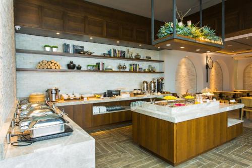 a large kitchen with a counter and a buffet at The Castle Ballet Taichung A Boutique Hotel in Taichung