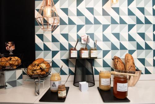 a bakery counter with bread and jars of honey at Mercure Lyon Charbonnières in Charbonnières-les-Bains