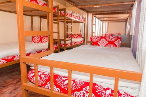 a bedroom with bunk beds with red and white pillows at Hostel Swastik in Bhaktapur