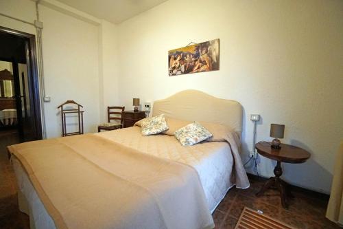 a bedroom with a bed with two pillows on it at Tenuta de Paoli in Castellina Marittima