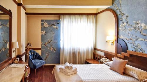 a hotel room with a bed and a window at Hotel Maria Luisa in Burgos