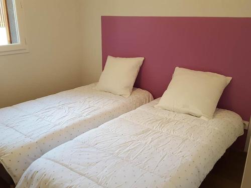 een slaapkamer met 2 bedden met witte lakens en kussens bij Terres Marines in Saint-Jean-de-Luz