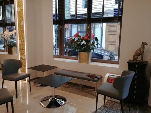 a room with chairs and a table and a window at Hotel Aida Opera in Paris
