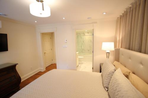 a bedroom with a bed and a bathroom at Water Street Condos in St. John's