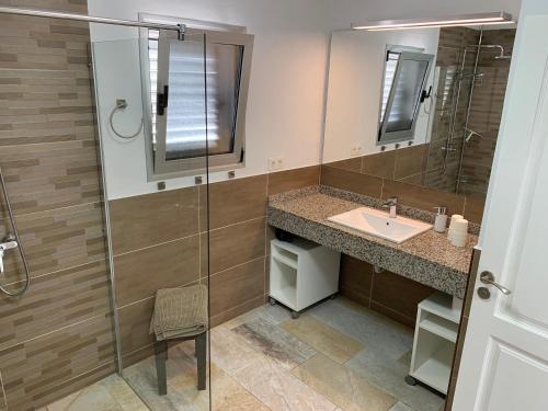 a bathroom with a sink and a shower at Villa Malagueñas in Puerto del Carmen