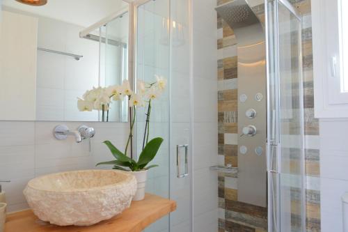 a bathroom with a bowl sink and a shower at Hawk Stone in Adamantas