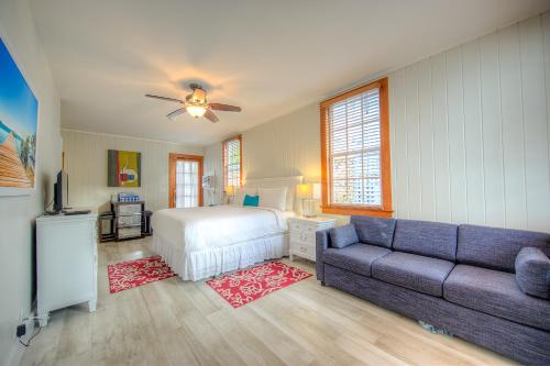 a bedroom with a bed and a couch at The Bartlum-Luxurious Studio in Key West