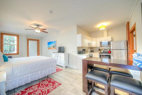 a bedroom with a bed and a kitchen at The Bartlum-Luxurious Studio in Key West