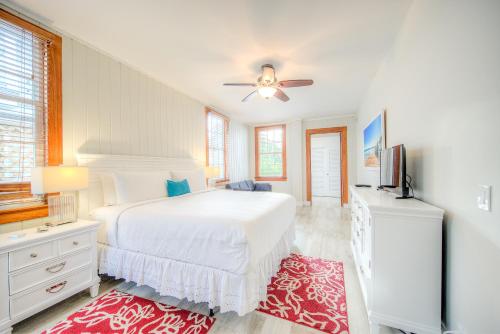 a white bedroom with a bed and a ceiling fan at The Bartlum-Luxurious Studio in Key West