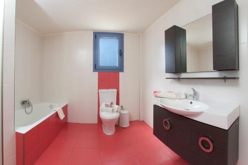 a bathroom with a toilet and a sink and a tub at Anatoli Villa in Agia Effimia