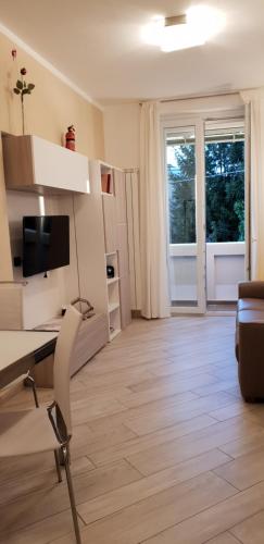 a living room with a desk and a television at Karina House - Como in Como