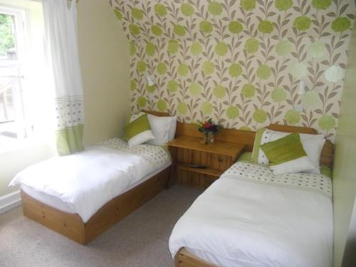 A bed or beds in a room at Ormidale Hotel