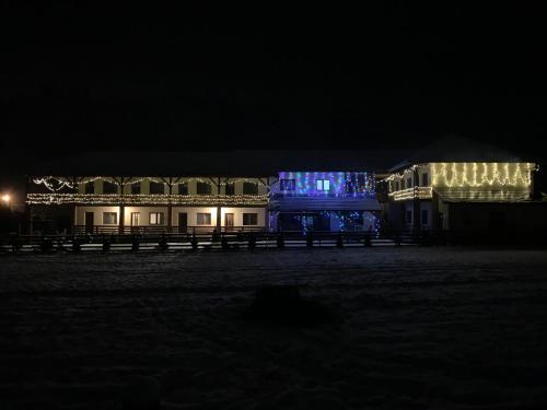 a building with christmas lights on it at night at Lex Studio in Praid