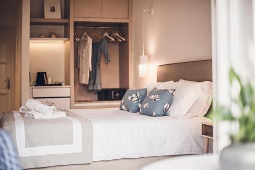 a bedroom with a large bed with pillows on it at Iliada Beach Hotel in Gouvia