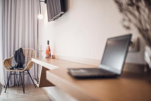 a laptop computer sitting on top of a kitchen counter at Iliada Beach Hotel in Gouvia