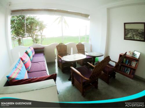 a living room with a couch and chairs and a table at Seagreen Guesthouse - Galle Fort in Galle