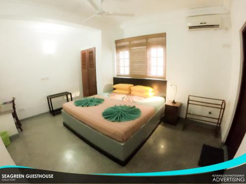 a bedroom with a large bed in a room at Seagreen Guesthouse - Galle Fort in Galle