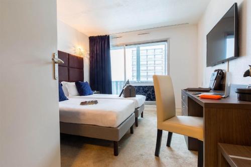 a hotel room with a bed and a desk at Madame Vacances - Hôtel Courchevel Olympic in Courchevel