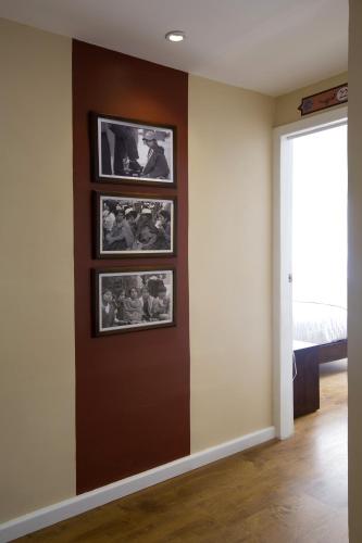 a living room with pictures on the wall at TERRA PREMIUM Hostal Boutique in Quito
