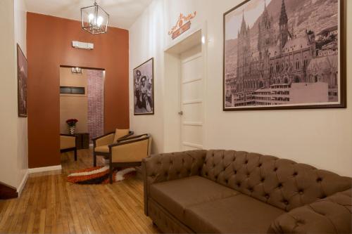 a living room with a couch and a table at TERRA PREMIUM Hostal Boutique in Quito