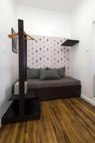 a bed in a room with a wooden floor at TERRA PREMIUM Hostal Boutique in Quito