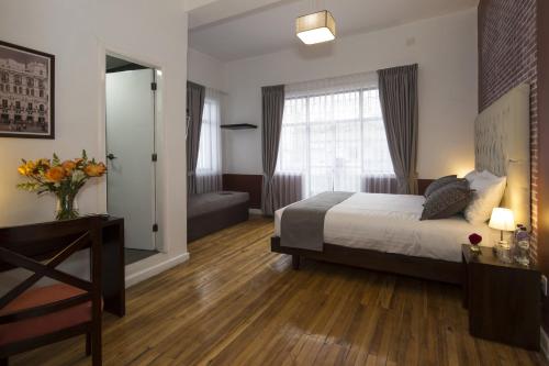 a hotel room with a bed and a window at TERRA PREMIUM Hostal Boutique in Quito