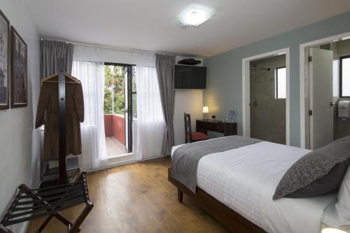 A bed or beds in a room at TERRA PREMIUM Hostal Boutique