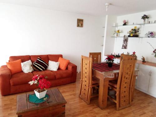 a living room with a couch and a table at Fresnos Residencia Queretaro - in Querétaro