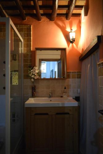 a bathroom with a sink and a mirror at Casa Cueva El Pocito in Peñaflor