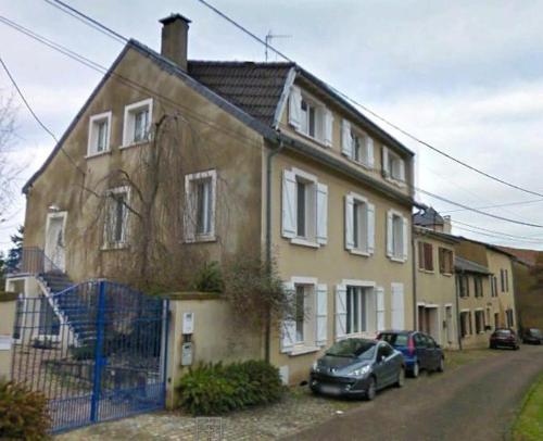 a house with a car parked in front of it at Les Jardins du Golf in Metz
