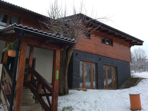 a house with a tree in front of it at Apartment Lazoň in Pavčina Lehota
