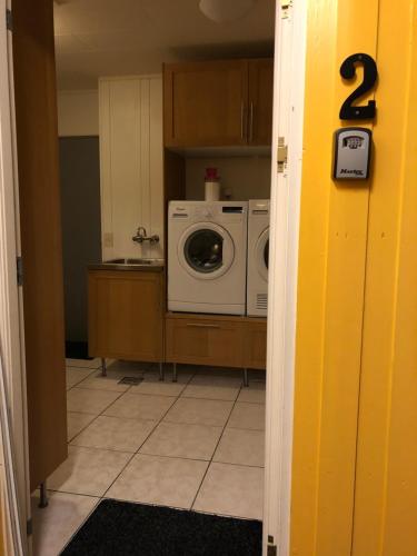 a laundry room with a washer and dryer at Sæból/Ocean Lair 2 in Grundarfjordur