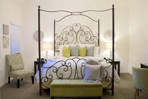 a bedroom with a bed and a chair at Andreas Hotel & Spa in Palm Springs