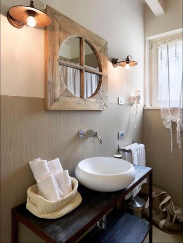 a bathroom with a sink and a mirror at Residence Relais Cà dell'Era in Tremosine Sul Garda