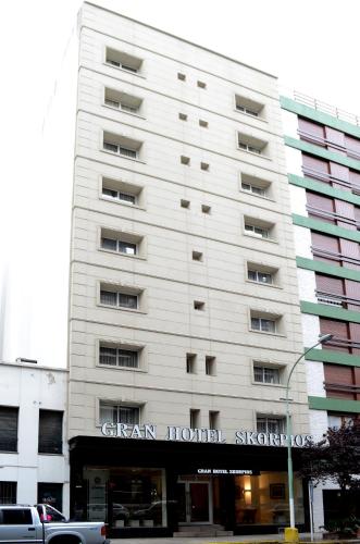 a tall white building with a sign on it at Gran Hotel Skorpios in Mar del Plata