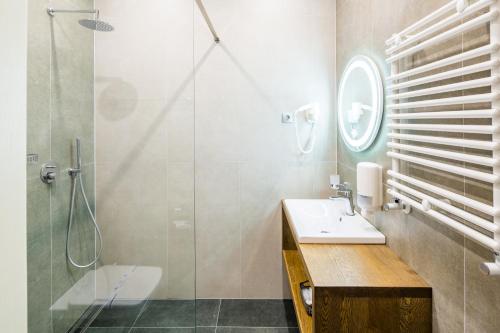 a bathroom with a sink and a shower at Hotel Rafael Готель Рафаель in Lviv