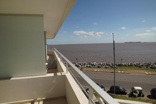 a balcony of a building with a view of the ocean at Dos Orillas Monoambiente 412 in Colonia del Sacramento