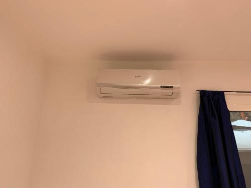 a room with a air conditioner on the wall at Appartamento Regonini in Alassio