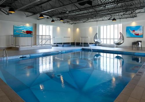 a swimming pool with blue water in a building at The Novotel Toronto Centre in Toronto