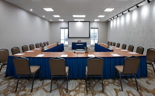 a conference room with a large table and chairs at The Novotel Toronto Centre in Toronto