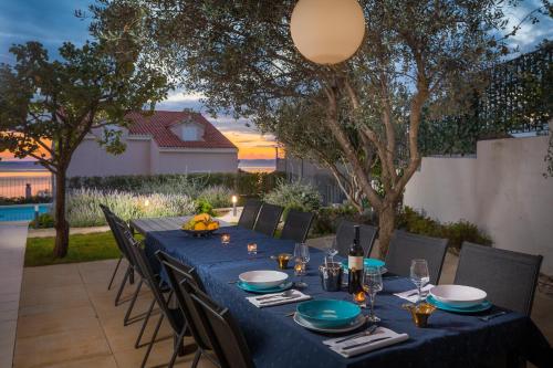 a table with a blue table cloth on a patio at Villa Elena in Podstrana