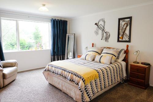 a bedroom with a bed and a window at Highview Drive Apartment in Nelson