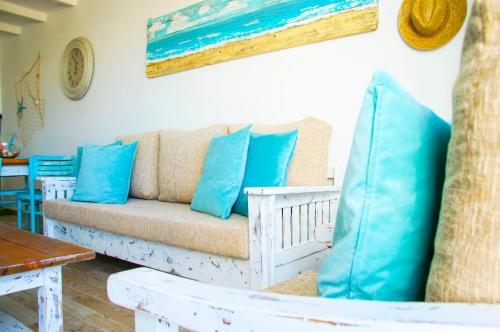 a couch with blue pillows in a living room at Casa Ada 2 in Famara