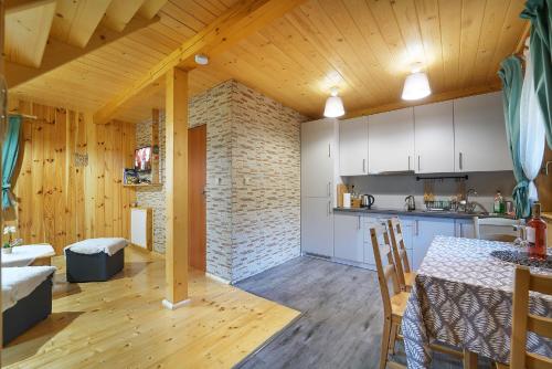 a kitchen and dining room with a table in a room at Domek Maja in Wisła