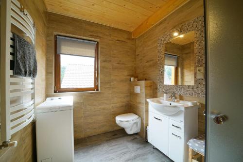 a small bathroom with a toilet and a sink at Domek Maja in Wisła