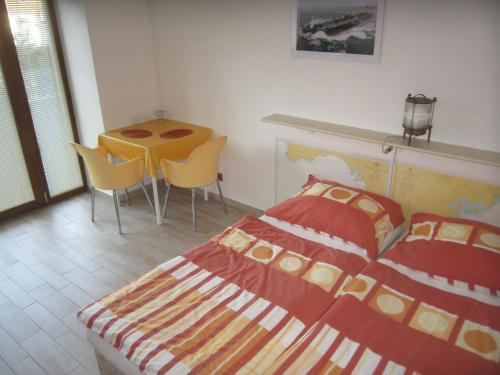 um quarto com uma cama, uma mesa e cadeiras em Penzion Letná em Velké Mezirici