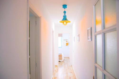 a hallway with a blue light hanging from a ceiling at Casa Ada 2 in Famara