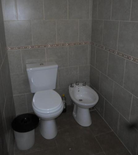 a bathroom with a toilet and a sink at La casita de Pablo in Santa Teresita