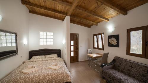 una camera con letto, tavolo e divano di Vila Pegaz a Virpazar